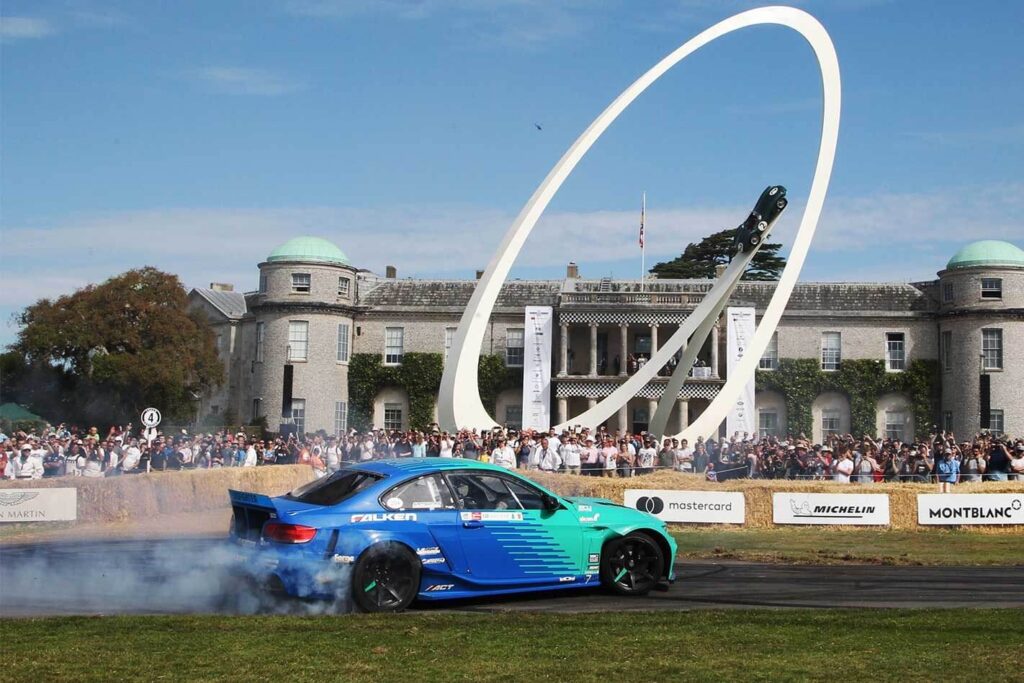 Blue car participating in the exciting Goodwood Festival events, showcasing motorsport excellence at Goodwood Estate